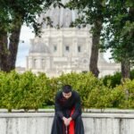 A Catholic priest in prayer near St. Peter's Basilica in Vatican City, Rome, Italy.