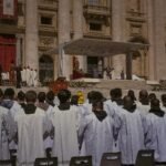 A large gathering of priests at a religious ceremony outside St. Peter's Basilica in Vatican City.