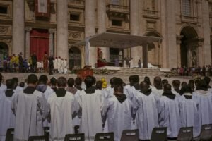 A large gathering of priests at a religious ceremony outside St. Peter's Basilica in Vatican City.